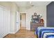 Bedroom with wood-look floors, closet and neutral paint at 8124 Brinegar Cir, Tampa, FL 33647