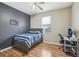 Bedroom features wood-look floors, a ceiling fan, and a desk at 8124 Brinegar Cir, Tampa, FL 33647