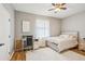 This bedroom has a ceiling fan, wood look floors and a desk at 8124 Brinegar Cir, Tampa, FL 33647