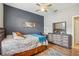 This bedroom has a ceiling fan, neutral walls, a blue accent wall and a wooden dresser with mirror at 8124 Brinegar Cir, Tampa, FL 33647