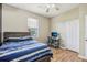 This bedroom has a ceiling fan, wood look floors and closet space at 8124 Brinegar Cir, Tampa, FL 33647