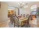 Formal dining room featuring a chandelier and an ornate table setting, perfect for hosting elegant dinners at 8124 Brinegar Cir, Tampa, FL 33647
