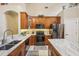 A kitchen featuring wooden cabinets, stainless appliances, granite countertops, and a kitchen island at 8124 Brinegar Cir, Tampa, FL 33647