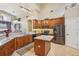 A kitchen with wooden cabinets, stainless appliances, granite countertops, and an island at 8124 Brinegar Cir, Tampa, FL 33647