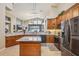 Kitchen featuring stainless appliances, light countertops, an island, and stone accents at 8124 Brinegar Cir, Tampa, FL 33647