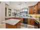 Kitchen featuring stainless appliances, light countertops, an island, and stone accents at 8124 Brinegar Cir, Tampa, FL 33647