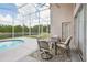 Enclosed lanai features a dining area and a view of the lake and backyard at 8124 Brinegar Cir, Tampa, FL 33647