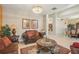 Cozy living room features a crystal chandelier, comfortable leather seating, and ornate decorative pieces at 8124 Brinegar Cir, Tampa, FL 33647