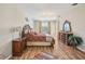 Bright main bedroom featuring hardwood floors, chandelier, and matching nightstands at 8124 Brinegar Cir, Tampa, FL 33647