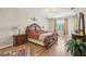Spacious main bedroom with hardwood floors, chandelier, and a large window at 8124 Brinegar Cir, Tampa, FL 33647