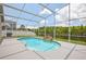 Screened in pool with waterfall feature and lovely view of the treeline and lake at 8124 Brinegar Cir, Tampa, FL 33647