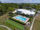 Aerial view of the community pool, shuffleboard courts, and clubhouse providing residents with recreational opportunities at 8174 Terrace Garden N Dr # 204, St Petersburg, FL 33709