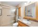 Bathroom features walk-in shower with grab bars and updated vanity at 8174 Terrace Garden N Dr # 204, St Petersburg, FL 33709