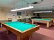 The billiard room features well-lit pool tables for residents to enjoy a game of billiards with friends and neighbors at 8174 Terrace Garden N Dr # 204, St Petersburg, FL 33709