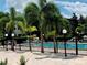 Community pool area with fencing, landscaping, and lounge chairs at 8174 Terrace Garden N Dr # 204, St Petersburg, FL 33709