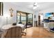 Bright dining area with wood floors and sliding glass doors to the lanai at 8174 Terrace Garden N Dr # 204, St Petersburg, FL 33709
