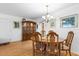 Eat-in dining room with wood floors, chandelier, wood furniture, and decor at 8174 Terrace Garden N Dr # 204, St Petersburg, FL 33709