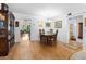 Dining room with wood floors, chandelier, dining table and chairs, and decorative cabinet at 8174 Terrace Garden N Dr # 204, St Petersburg, FL 33709