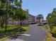 A well-maintained condominium complex showcases its architectural design and lush green surroundings on a clear day at 8174 Terrace Garden N Dr # 204, St Petersburg, FL 33709