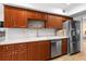 Well-organized kitchen with stainless steel appliances, laminate countertops, and wood cabinets at 8174 Terrace Garden N Dr # 204, St Petersburg, FL 33709