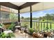 Enclosed lanai with tile floors, plants, and views of a lake at 8174 Terrace Garden N Dr # 204, St Petersburg, FL 33709
