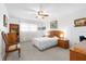 Bright main bedroom with carpet, ceiling fan, and a large window at 8174 Terrace Garden N Dr # 204, St Petersburg, FL 33709