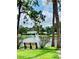Picturesque view of the community pond with a fountain, bench, and lush landscaping at 8174 Terrace Garden N Dr # 204, St Petersburg, FL 33709