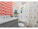 Clean bathroom with patterned accent wall, a combined tub and shower, and a modern vanity with sink at 8208 Praise Dr, Tampa, FL 33625