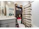 Bathroom with decorative shower curtain and sink with storage at 8208 Praise Dr, Tampa, FL 33625