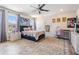 Spacious bedroom with wood-look floors, natural light, and a decorative rug, perfect for relaxation and comfort at 8208 Praise Dr, Tampa, FL 33625
