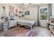 Cozy bedroom with wood-look floors, large window, and colorful rug, creating a warm and inviting atmosphere at 8208 Praise Dr, Tampa, FL 33625
