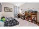 Bedroom area featuring a cozy bed with desk and bookshelf at 8208 Praise Dr, Tampa, FL 33625