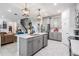 Bright open kitchen features stainless appliances, a kitchen island and decorative hanging lamps at 8208 Praise Dr, Tampa, FL 33625