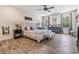 Main bedroom featuring a decorative bed, wood floors, and decorative windows at 8208 Praise Dr, Tampa, FL 33625