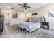 Main bedroom with wood-like floors and decorative lamps on both sides of the bed at 8208 Praise Dr, Tampa, FL 33625