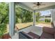 Covered patio with comfortable seating, ceiling fan, and string lights, ideal for outdoor relaxation and entertaining at 8208 Praise Dr, Tampa, FL 33625