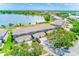Aerial view of lakefront property with lush trees and ample parking at 8253 118Th Ave, Largo, FL 33773