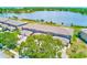 Stunning aerial view of the property with lake, lush trees, and ample parking at 8253 118Th Ave, Largo, FL 33773