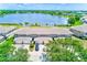 Beautiful aerial view of townhomes with a serene lake backdrop and lush green landscaping creating a peaceful community at 8253 118Th Ave, Largo, FL 33773