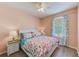 Cozy bedroom with white furniture, ceiling fan, wood-look flooring, and natural light at 8253 118Th Ave, Largo, FL 33773