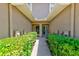 Inviting front entrance framed by manicured hedges creating a warm welcome at 8253 118Th Ave, Largo, FL 33773