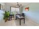Well-lit home office features a ceiling fan, a large window, and tile flooring at 8253 118Th Ave, Largo, FL 33773
