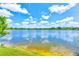 Scenic view of the lakefront property on a bright, sunny day at 8253 118Th Ave, Largo, FL 33773
