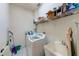 Laundry room with washer, dryer, utility sink, and shelving at 8253 118Th Ave, Largo, FL 33773