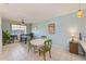 Open living area with dining table, ceiling fan, lots of natural light, and tile flooring at 8253 118Th Ave, Largo, FL 33773
