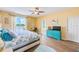 Bright bedroom with lake view, ceiling fan, desk, and access to ensuite bathroom at 8253 118Th Ave, Largo, FL 33773