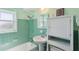 Bathroom features a shower-tub combo, vanity sink, and mint green tiles at 841 4Th N Ave # 55, St Petersburg, FL 33701