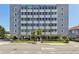 Suncoast Towers building featuring a gray exterior, ample windows, and a well-manicured lawn at 841 4Th N Ave # 55, St Petersburg, FL 33701