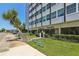 Exterior view of Suncoast Towers featuring manicured landscaping and a sidewalk at 841 4Th N Ave # 55, St Petersburg, FL 33701