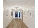 Hallway featuring light walls, wood-look floors, apartment doors, and updated light fixtures at 841 4Th N Ave # 55, St Petersburg, FL 33701